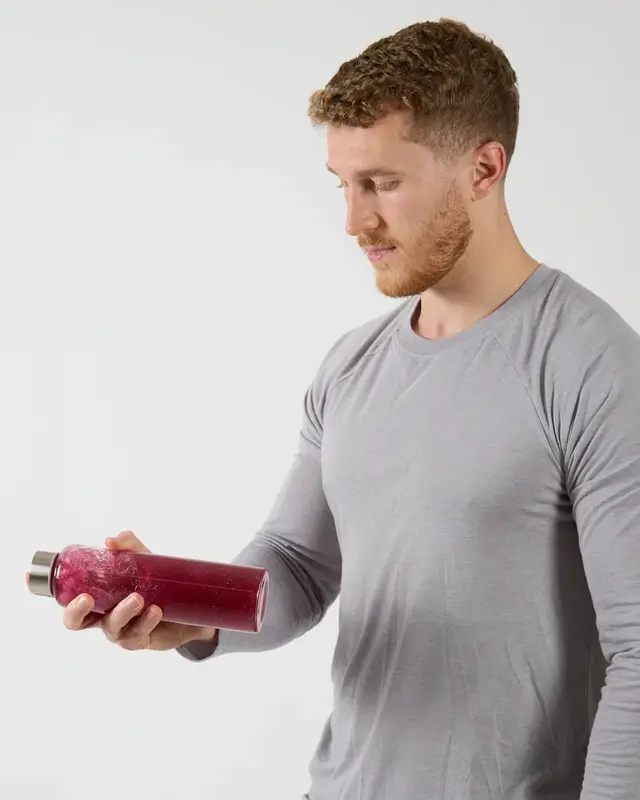 Dom Oddy holding a drink bottle.